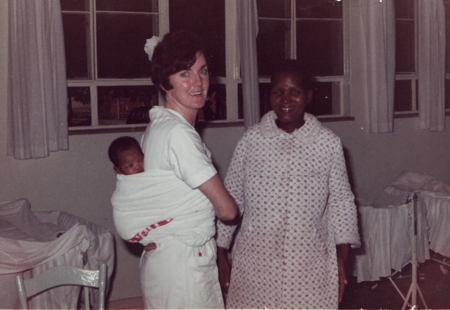 Fig. 1 Midwifery nurse demonstrating safe method of carrying an infant on the back in a marsupial-pouch wrap (image courtesy of Sister Joan Body)